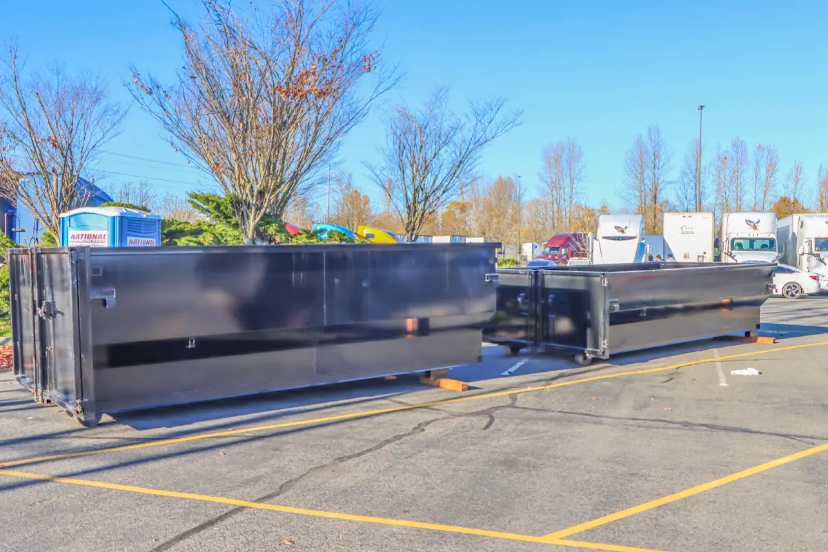 Professional dumpster rental service with roll-off container on residential driveway in Fox Crossing